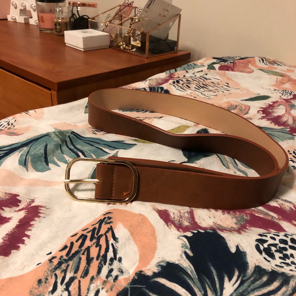Slightly worn brown belt wit gold buckle